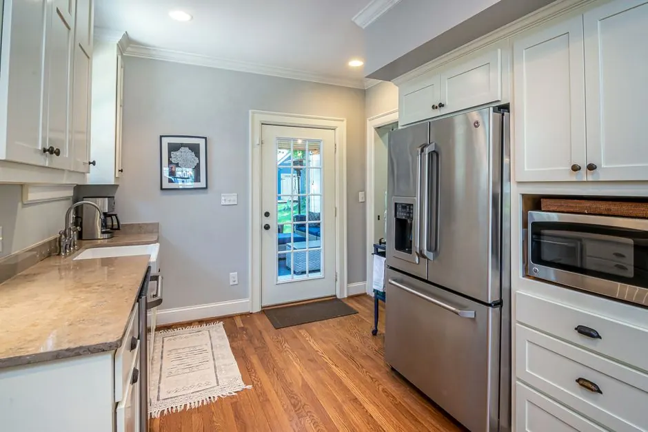 Bright kitchen with stainless steel appliances and a refrigerator
