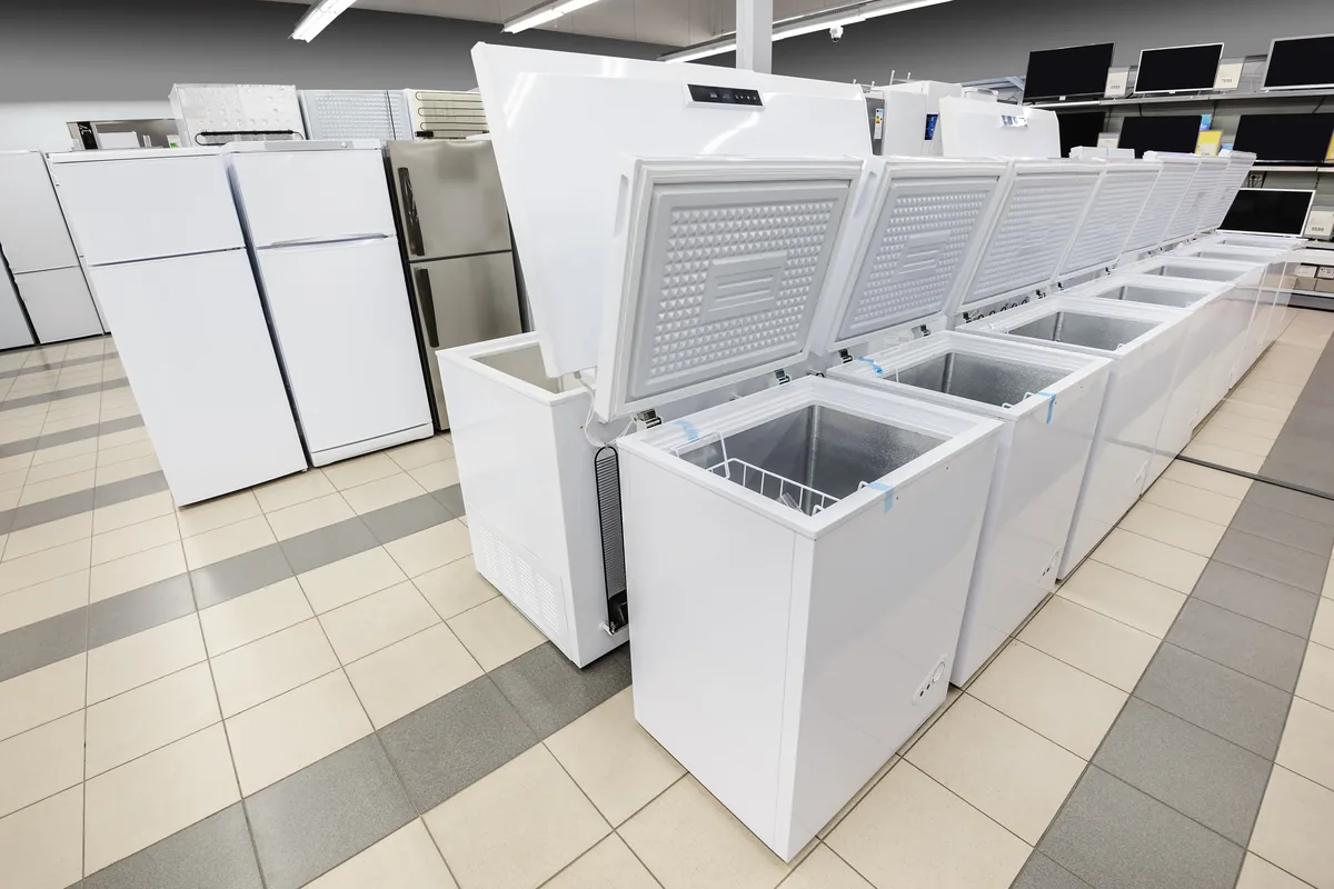 Row of chest freezers and refrigerators