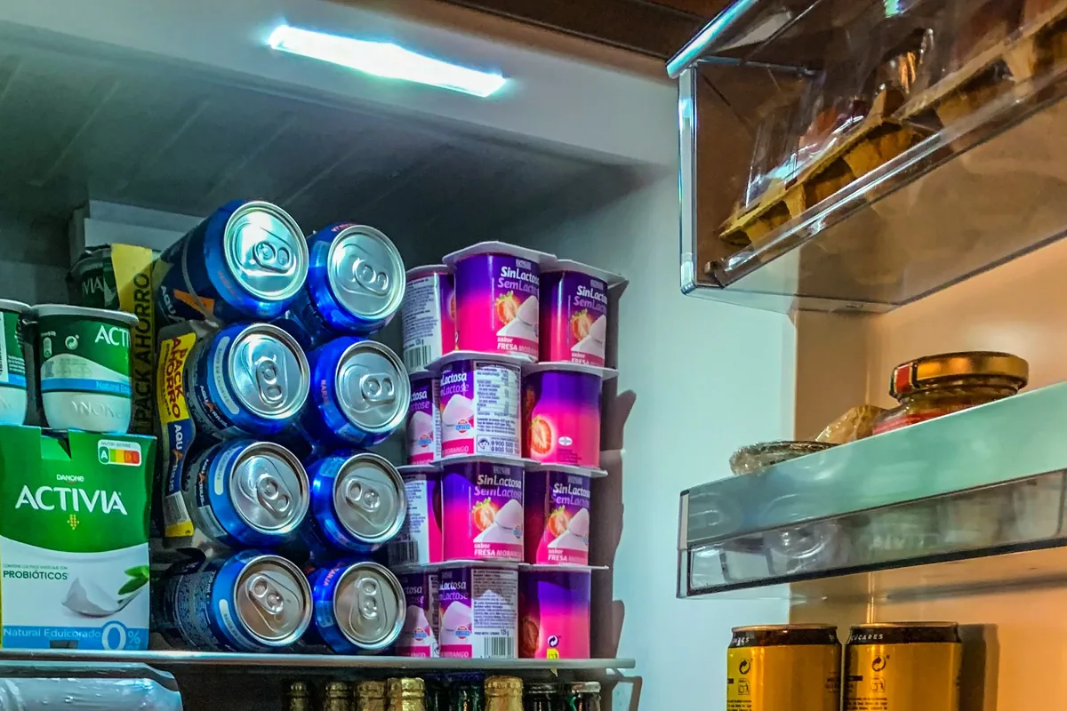 Open refrigerator with shelves of stocked food and drinks