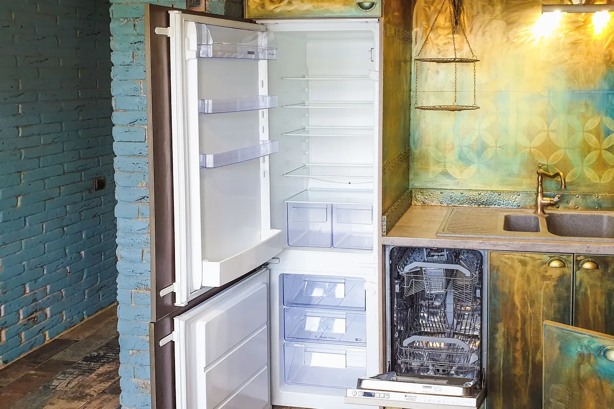 Open refrigerator interior with shelves and drawers